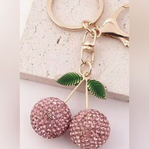 Pink Sparkling Cherry Keychain with Gold Accents and Green Leaves